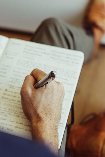 Man Making Notes In His Diary